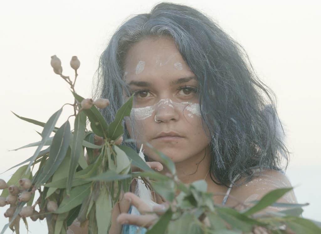 Aboriginal girl holding gum leaves